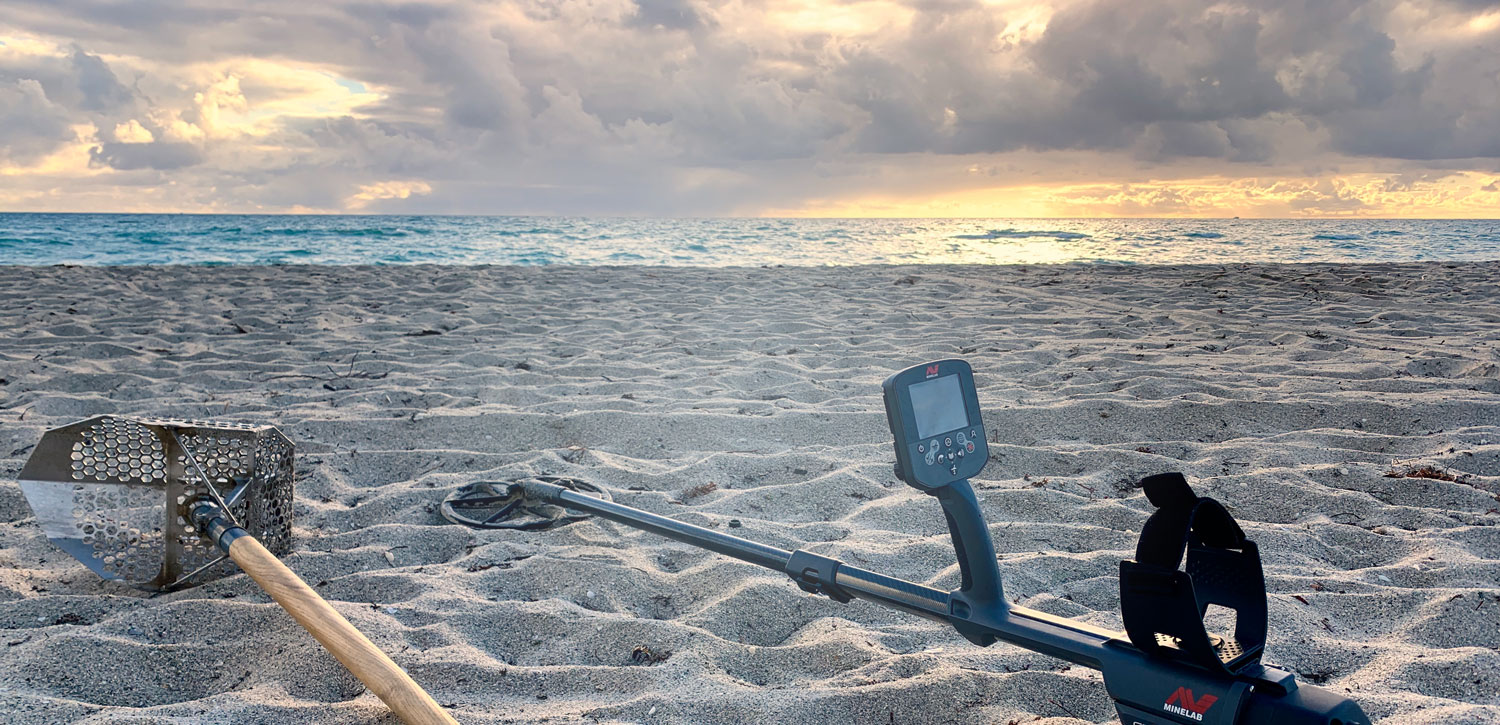 Minelab CTX-3030 on a beach with scoop for metal detecting