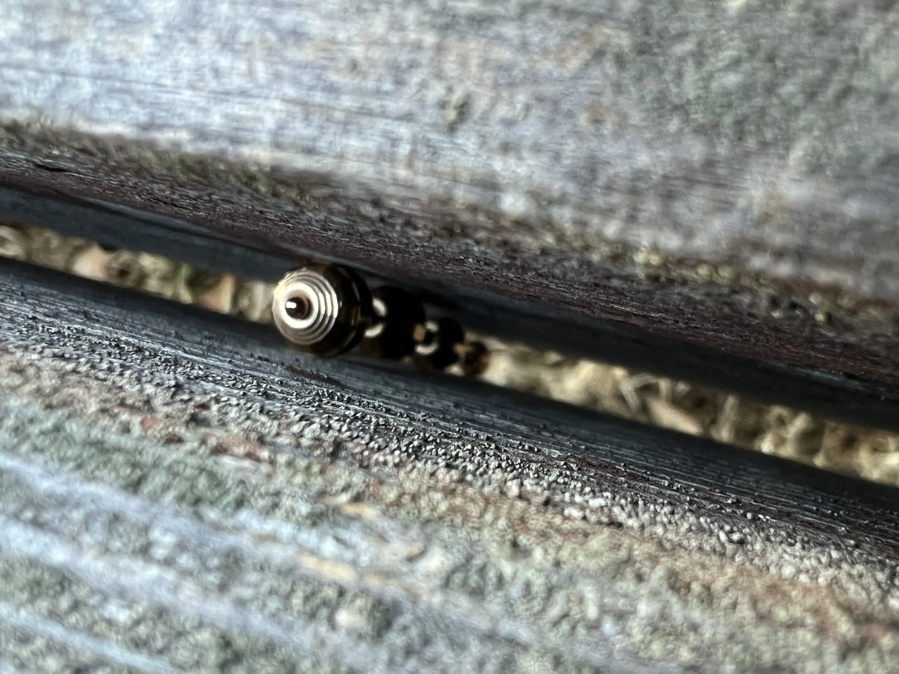 Pendant lodged inside a bench slat