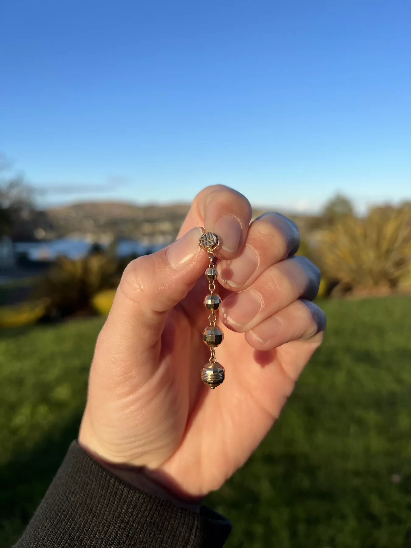Missing necklace pendant recovered - hand showing the pendant
